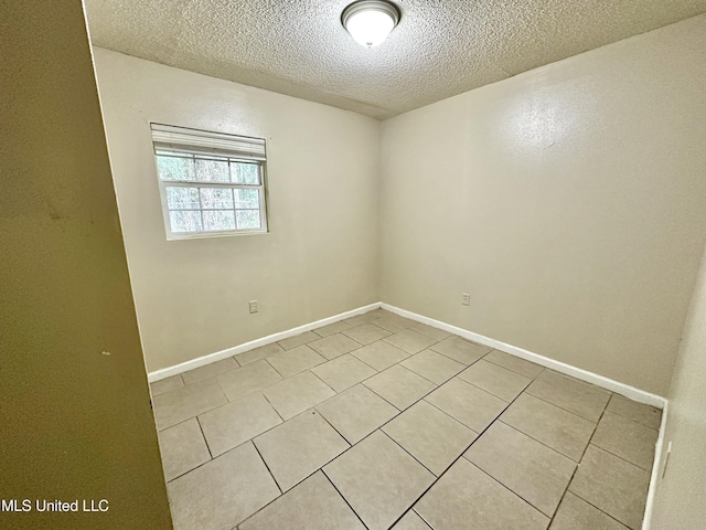 spare room with a textured ceiling