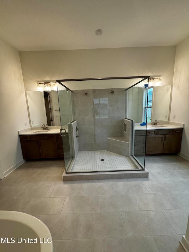 bathroom featuring tile patterned flooring, vanity, and separate shower and tub