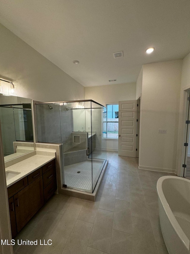 bathroom with vanity, independent shower and bath, and tile patterned flooring