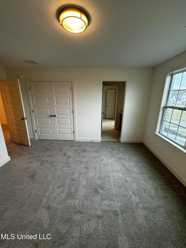 unfurnished bedroom with carpet and a closet