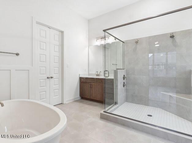 bathroom featuring vanity and separate shower and tub