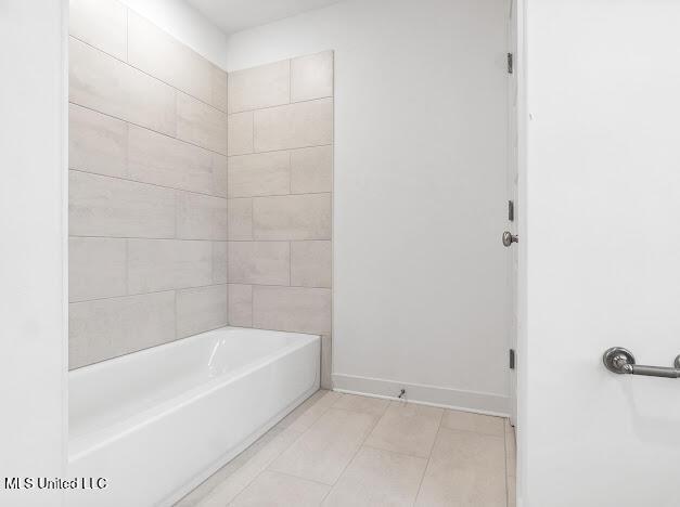 bathroom with tile patterned flooring and tiled shower / bath combo