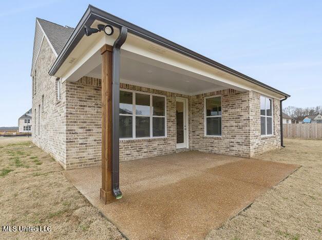 back of property with a patio