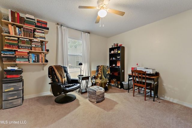 sitting room with a textured ceiling, ceiling fan, and light carpet