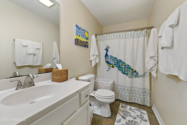 bathroom with vanity, curtained shower, toilet, and a textured ceiling