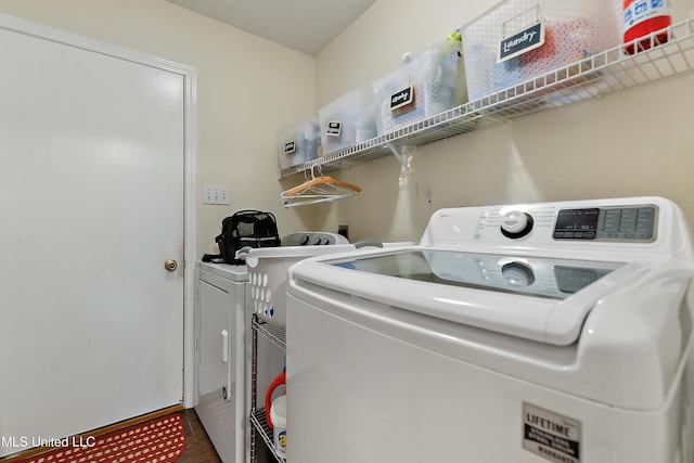 laundry area featuring wood-type flooring and independent washer and dryer