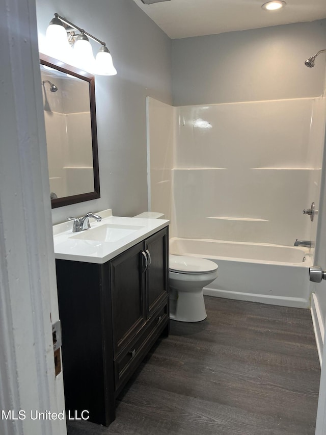 3715 Parkview St, Vicksburg, MS 39180 - bathroom with toilet, vanity, tub / shower combination, and wood finished floors