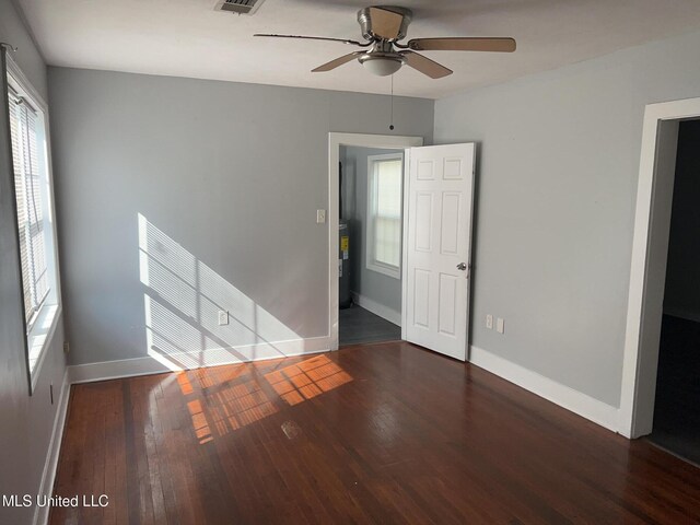 3715 Parkview St, Vicksburg, MS 39180 - unfurnished bedroom featuring baseboards, wood finished floors, and a ceiling fan