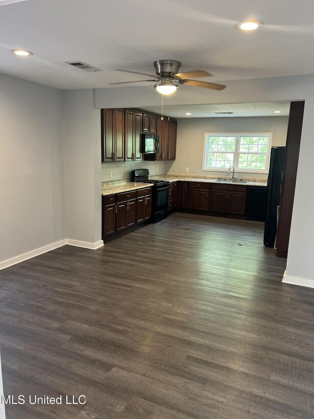 3715 Parkview St, Vicksburg, MS 39180 - kitchen with light countertops, dark wood-type flooring, a sink, dark brown cabinets, and black appliances