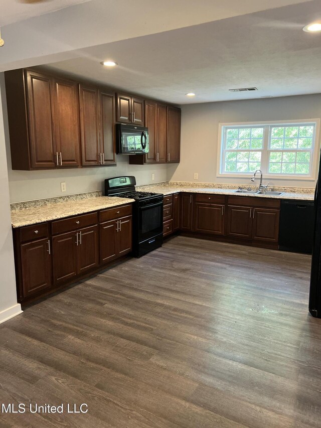 3715 Parkview St, Vicksburg, MS 39180 - kitchen with recessed lighting, dark wood finished floors, dark brown cabinetry, a sink, and black appliances