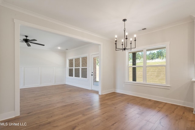 interior space featuring ornamental molding, wood-type flooring, and ceiling fan with notable chandelier