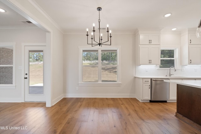 kitchen with light hardwood / wood-style flooring, stainless steel dishwasher, and white cabinets