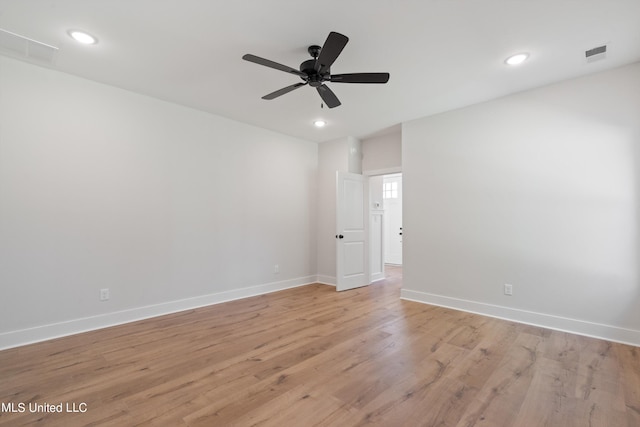 spare room featuring light hardwood / wood-style flooring and ceiling fan