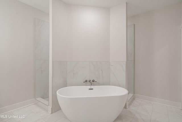 bathroom featuring tile walls and independent shower and bath