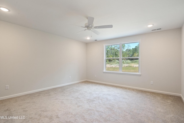 spare room with carpet floors and ceiling fan