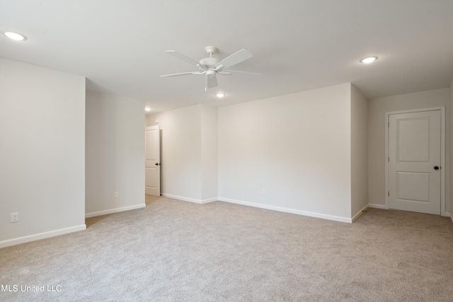 empty room with light colored carpet and ceiling fan