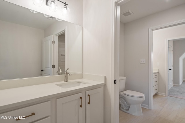 bathroom featuring toilet and vanity