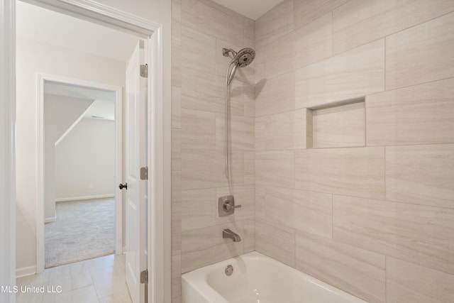 bathroom featuring tiled shower / bath combo and tile patterned floors