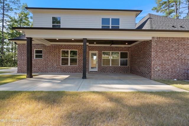 back of house with a yard, a patio, and ceiling fan