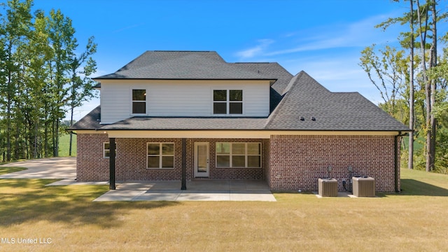 rear view of property with a patio, central AC, and a lawn