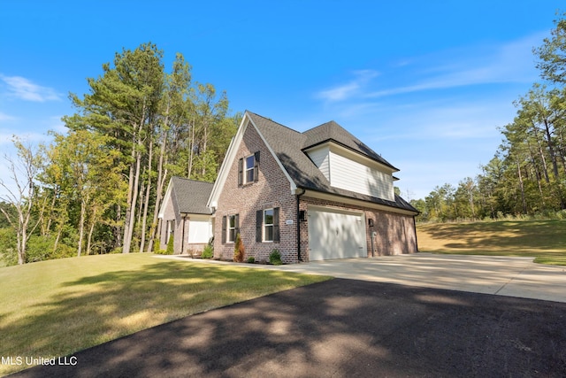 view of front of property featuring a front lawn and a garage