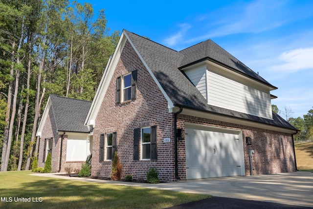 view of home's exterior with a lawn and a garage