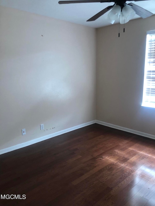 spare room featuring ceiling fan and dark hardwood / wood-style flooring