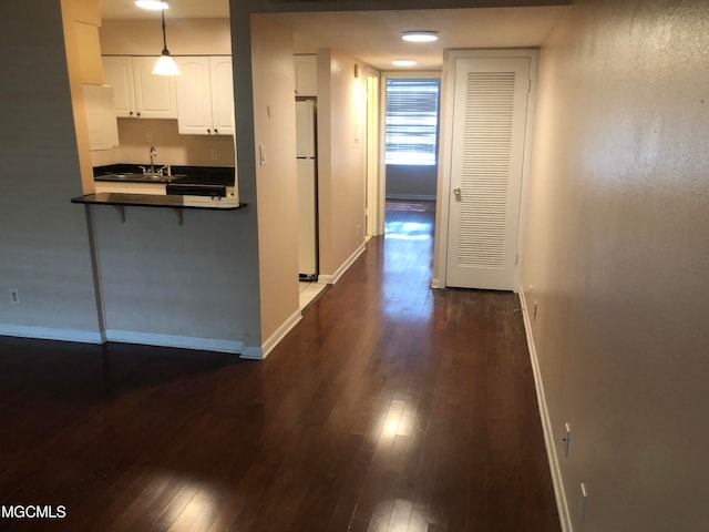 hall featuring sink and dark hardwood / wood-style flooring