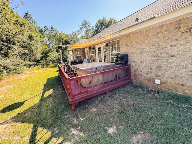 view of yard with a wooden deck and a hot tub