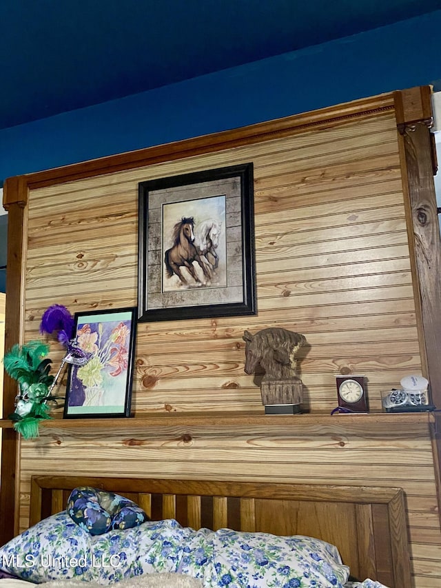 bedroom featuring wood walls