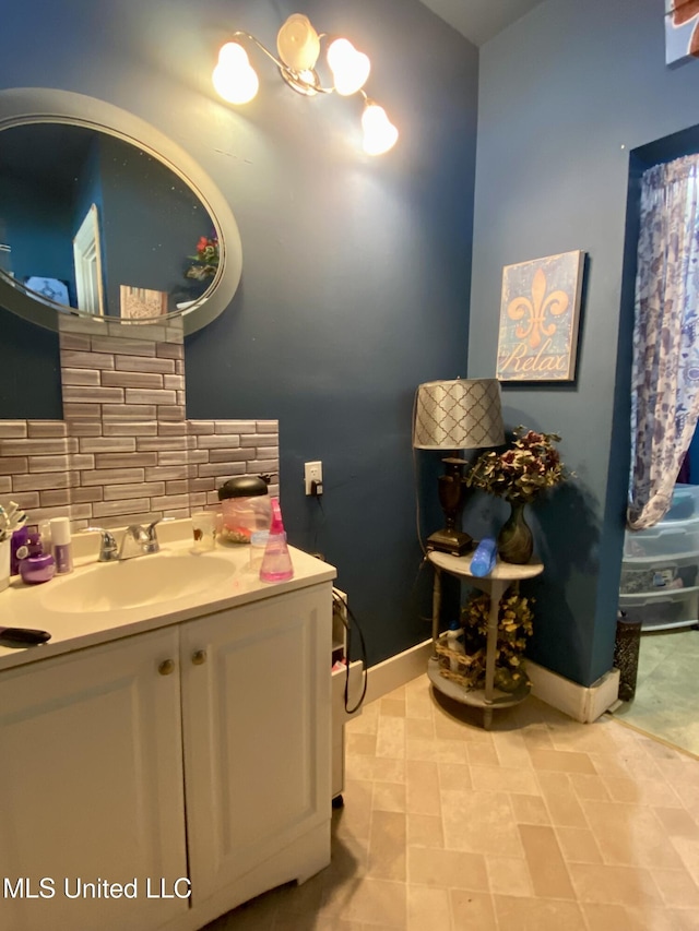 bathroom with tasteful backsplash, vanity, and tile patterned flooring