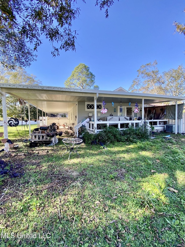 view of front facade featuring central AC, covered porch, and a front yard