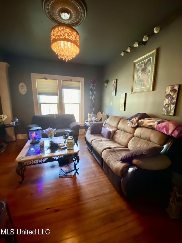 living room with an inviting chandelier and hardwood / wood-style floors