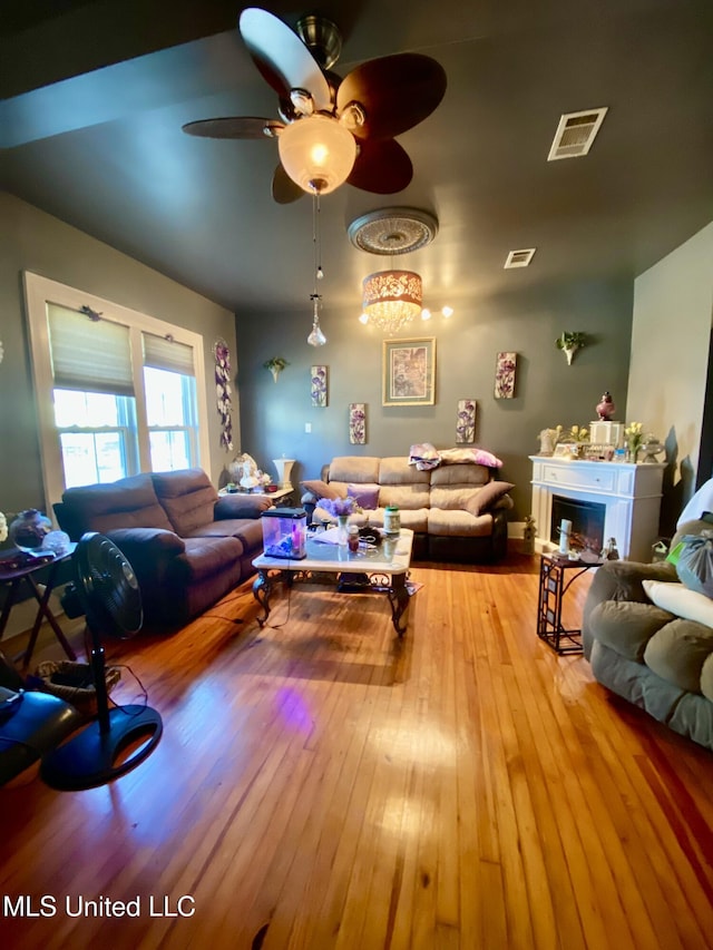 living room featuring light hardwood / wood-style floors and ceiling fan