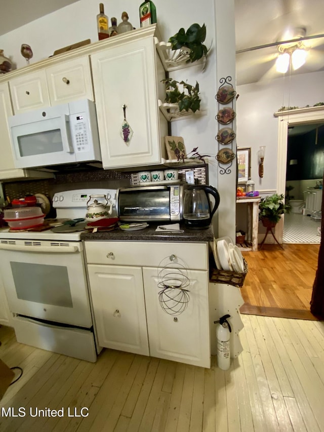 kitchen featuring white appliances, white cabinets, and light wood-type flooring