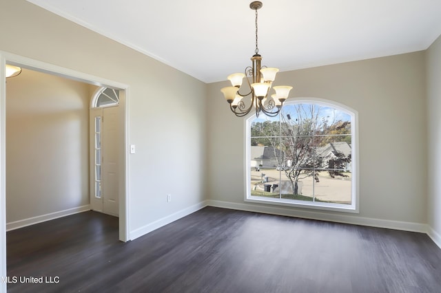 empty room featuring a chandelier and dark hardwood / wood-style flooring