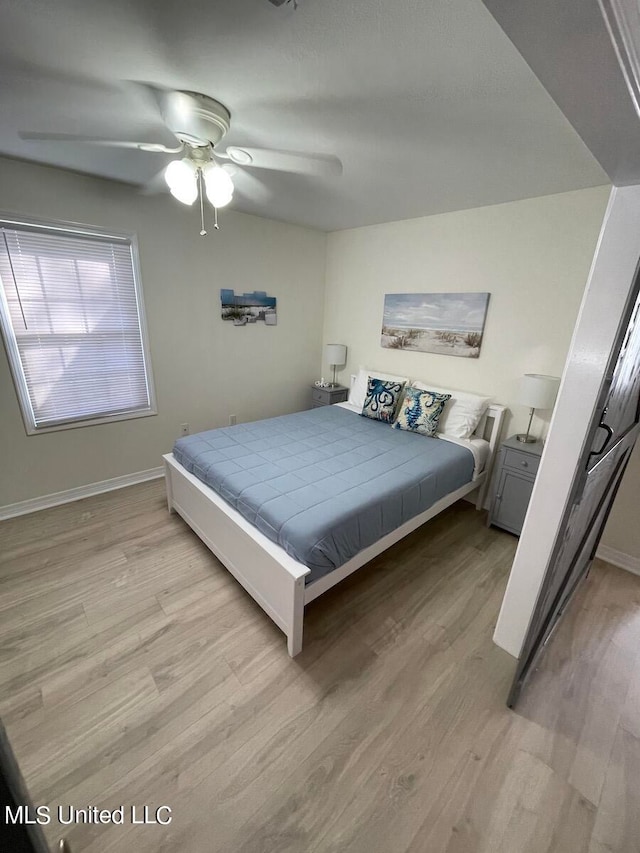 bedroom with light hardwood / wood-style flooring and ceiling fan