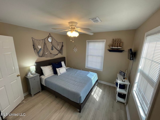 bedroom with light hardwood / wood-style floors and ceiling fan