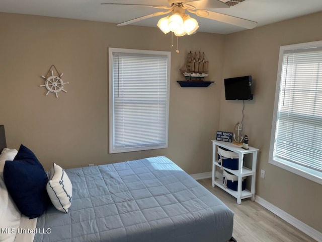 bedroom featuring light hardwood / wood-style flooring and ceiling fan