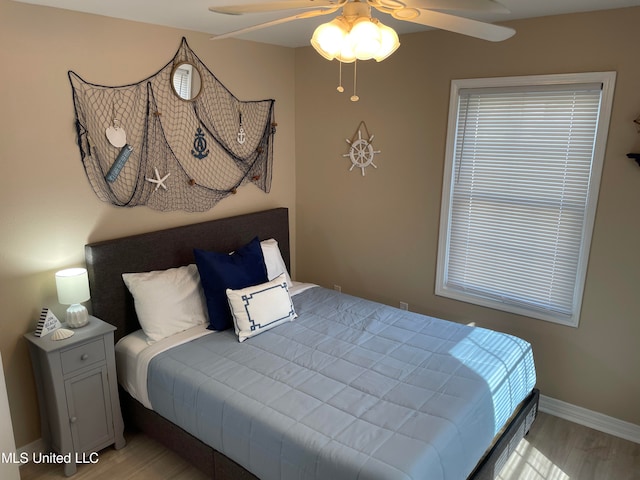 bedroom with ceiling fan and light hardwood / wood-style flooring