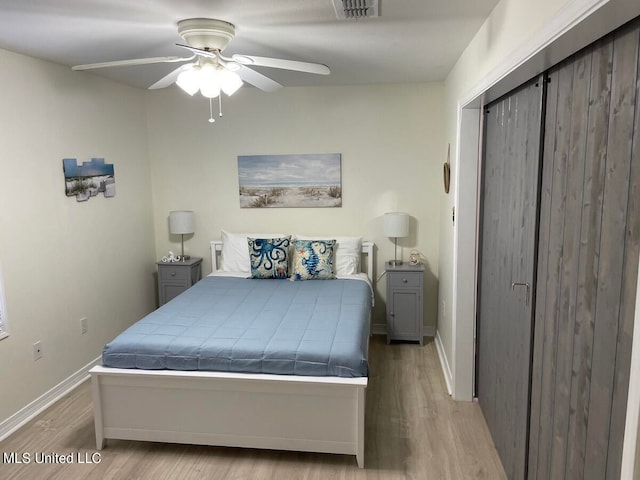 bedroom with light hardwood / wood-style flooring and ceiling fan