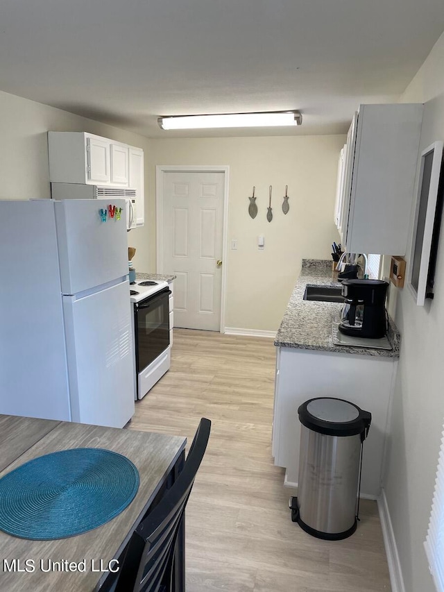 kitchen with white cabinetry, light stone countertops, light hardwood / wood-style flooring, sink, and white appliances