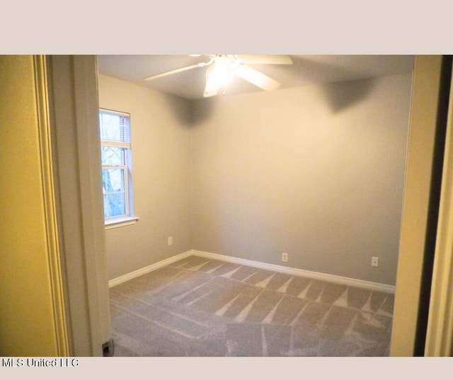 carpeted empty room with a ceiling fan and baseboards