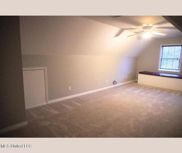 additional living space featuring carpet flooring, baseboards, and lofted ceiling