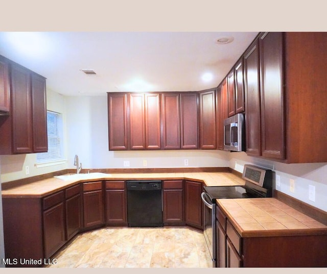 kitchen with visible vents, tile countertops, recessed lighting, stainless steel appliances, and a sink