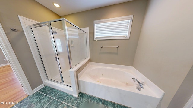 bathroom featuring a garden tub, tile patterned flooring, and a shower stall