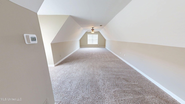 additional living space with baseboards, lofted ceiling, ceiling fan, and carpet floors