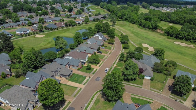 birds eye view of property with golf course view, a water view, and a residential view
