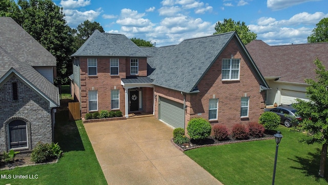 view of front of home featuring roof with shingles, brick siding, concrete driveway, a garage, and a front lawn