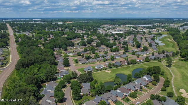 drone / aerial view featuring a water view, a residential view, and view of golf course